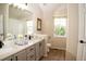 Bright bathroom with double sinks, modern fixtures, and a window for natural light at 6845 S Webster St # E, Littleton, CO 80128