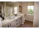 Modern bathroom featuring double sinks, granite countertops, and contemporary fixtures at 6845 S Webster St # E, Littleton, CO 80128
