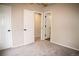 Bedroom view showcases plush neutral carpeting, white doors, and multiple entrances at 6845 S Webster St # E, Littleton, CO 80128