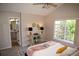 Bright bedroom showcasing a ceiling fan, neutral tones, and a large window at 6845 S Webster St # E, Littleton, CO 80128