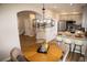 Stylish dining area with a modern light fixture, table, and kitchen view at 6845 S Webster St # E, Littleton, CO 80128