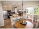 Open kitchen and dining area with modern lighting and sliding door access at 6845 S Webster St # E, Littleton, CO 80128
