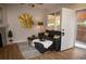Comfortable living room with a dark sofa, decor, and access to the outdoors at 6845 S Webster St # E, Littleton, CO 80128