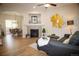 Inviting living room boasts hardwood floors, fireplace, and open layout to dining area at 6845 S Webster St # E, Littleton, CO 80128