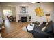 Inviting living room boasts hardwood floors, fireplace, and open layout to dining area at 6845 S Webster St # E, Littleton, CO 80128