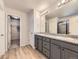 Bathroom featuring double sinks, granite countertops, and a walk-in shower at 917 White Leaf Cir, Castle Rock, CO 80108