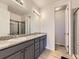 Modern bathroom featuring a dual sink vanity, granite countertops, and a tiled walk-in shower at 917 White Leaf Cir, Castle Rock, CO 80108