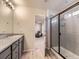 Bathroom featuring double sinks, granite countertops, and a walk-in shower at 917 White Leaf Cir, Castle Rock, CO 80108