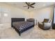 Spacious bedroom with a ceiling fan, a bed, a crib, an armchair and neutral decor at 917 White Leaf Cir, Castle Rock, CO 80108