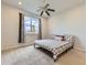 Cozy bedroom with a floral patterned bed frame, a ceiling fan and a window with view at 917 White Leaf Cir, Castle Rock, CO 80108