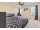 Bright bedroom featuring a cozy bed, crib, armchair and two large windows, providing ample natural light at 917 White Leaf Cir, Castle Rock, CO 80108