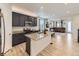 Spacious kitchen with dark cabinets, granite countertops, an island, and seamlessly connected to the living room at 917 White Leaf Cir, Castle Rock, CO 80108