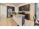 Well-lit kitchen boasts an island, granite countertops, stainless steel appliances, and dark cabinetry at 917 White Leaf Cir, Castle Rock, CO 80108