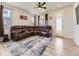 Bright living room featuring wood floors, a sectional sofa, and a glass paneled door at 917 White Leaf Cir, Castle Rock, CO 80108