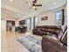 Open-concept living room connects to the kitchen, featuring wood floors, a large couch and ample natural light at 917 White Leaf Cir, Castle Rock, CO 80108