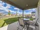 Covered patio with outdoor dining set, offering a relaxing space for entertaining overlooking the backyard at 917 White Leaf Cir, Castle Rock, CO 80108