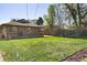 Spacious backyard with a well-maintained lawn, mature trees, and a wooden fence at 3025 Forest St, Denver, CO 80207