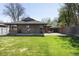 Expansive backyard with lush green grass and a brick house at 3025 Forest St, Denver, CO 80207