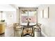 Cozy dining area with a round table, stylish chairs, and view of the outdoor patio through glass doors at 3025 Forest St, Denver, CO 80207