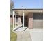 Close-up of home's entryway showing the covered porch, brick detail, and attached garage at 3025 Forest St, Denver, CO 80207