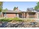 Single-story brick home with a tidy front yard, covered porch, and attached garage, ready for move-in at 3025 Forest St, Denver, CO 80207
