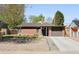 Charming brick home with attached garage, well-kept lawn, and inviting curb appeal at 3025 Forest St, Denver, CO 80207