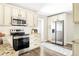 Well-lit kitchen boasts stainless steel appliances, granite counters, and ample cabinet space at 3025 Forest St, Denver, CO 80207