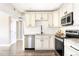 Updated kitchen featuring granite countertops, white cabinetry, and stainless steel appliances at 3025 Forest St, Denver, CO 80207