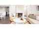 Open living room featuring a fireplace, neutral-toned furniture, and a view into the modern kitchen at 3025 Forest St, Denver, CO 80207