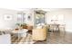 Open-concept living and dining area with modern decor, abundant natural light, and hardwood floors at 3025 Forest St, Denver, CO 80207