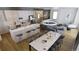 Open floor plan includes a dining table, kitchen island with bar stools, and modern lighting fixtures at 621 Lombardi Cir, Louisville, CO 80027