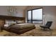 Modern bedroom with a cozy bed, artwork, and a comfortable accent chair by a large window at 621 Lombardi Cir, Louisville, CO 80027