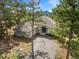 Aerial view of a single-Gathering home with a driveway and large trees in the community at 31042 Wildwoods, Evergreen, CO 80439