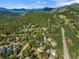 Panoramic aerial of Evergreen homes with winding roads amidst dense trees at 31042 Wildwoods, Evergreen, CO 80439