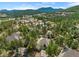 Beautiful aerial view of Evergreen homes surrounded by trees and mountain views at 31042 Wildwoods, Evergreen, CO 80439