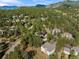 High-angle view of Evergreen homes nestled among dense, verdant trees at 31042 Wildwoods, Evergreen, CO 80439