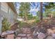 Side yard with stone and brick pathway leading up to the home's back yard at 31042 Wildwoods, Evergreen, CO 80439