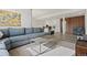 Finished basement with large sectional couch, coffee table, and wood accent wall at 31042 Wildwoods, Evergreen, CO 80439