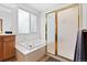 Bathroom features a shower and soaking tub with window at 31042 Wildwoods, Evergreen, CO 80439