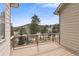 Wooden deck overlooks the treed community with mountain views in the distance at 31042 Wildwoods, Evergreen, CO 80439