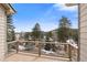 Wooden deck overlooks the treed community with mountain views in the distance at 31042 Wildwoods, Evergreen, CO 80439