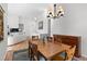 Bright dining room featuring a wood table, ornate chandelier, and hardwood floors at 31042 Wildwoods, Evergreen, CO 80439