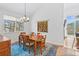 Dining room with hardwood floors, wooden table and chairs, and bright windows with views at 31042 Wildwoods, Evergreen, CO 80439