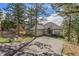 Attractive home with stone accents, a two-car garage, and mature trees at 31042 Wildwoods, Evergreen, CO 80439