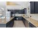 Modern kitchen featuring stainless steel appliances, dark wood cabinets, and tile floors at 31042 Wildwoods, Evergreen, CO 80439