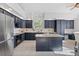Open kitchen with dark cabinetry, stainless steel appliances, and a functional center island at 31042 Wildwoods, Evergreen, CO 80439