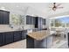 Well-lit kitchen featuring dark cabinets, stainless steel appliances, and granite countertops at 31042 Wildwoods, Evergreen, CO 80439