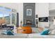 Bright living room with a cozy fireplace, balcony, and comfortable seating at 31042 Wildwoods, Evergreen, CO 80439