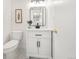 Bathroom featuring a white vanity with black hardware, modern lighting and toilet at 6463 S Vance St, Littleton, CO 80123