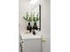 Bathroom featuring a marble vanity with black hardware, and decorative plants at 6463 S Vance St, Littleton, CO 80123